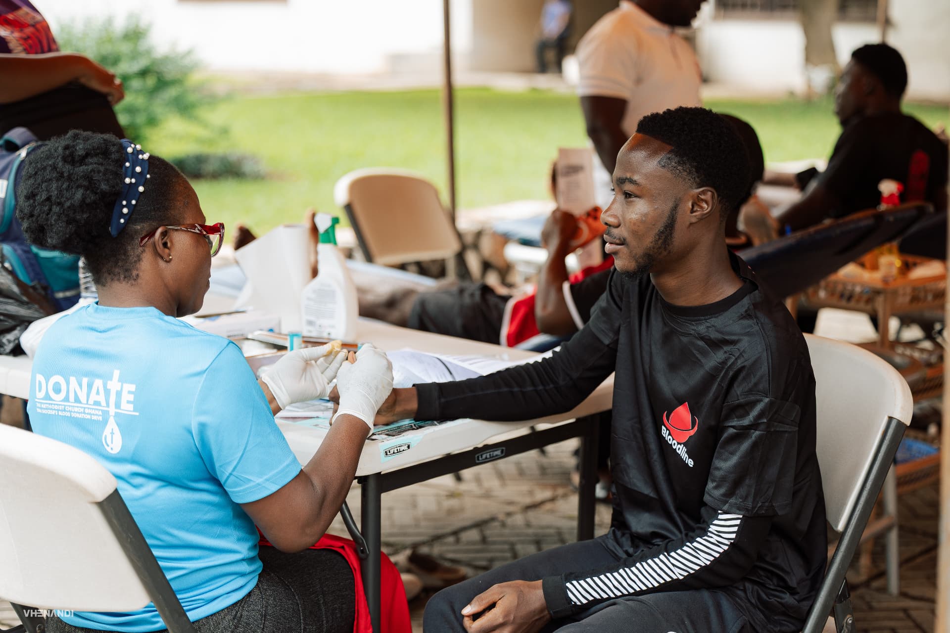 A donor being screened by a healthcare worker at a Bloodline drive